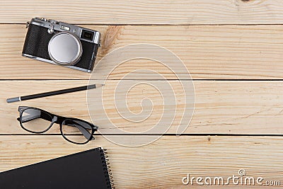 Writer, journalist or traveler desk - notepad and photo camera on the wooden background Stock Photo