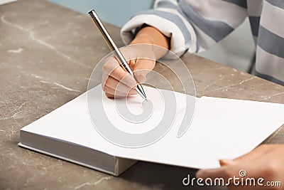 Writer signing autograph in book Stock Photo