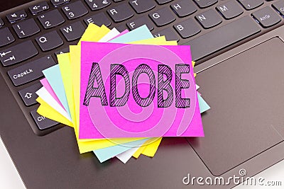 Writing ADOBE text made in the office close-up on laptop computer keyboard. Business concept for Software Company Name Workshop on Editorial Stock Photo