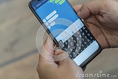 Writing alien messages with hieroglyphs on a smartphone Stock Photo