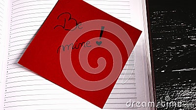 Writing be mine on memo post reminder. Text on sticky paper Stock Photo