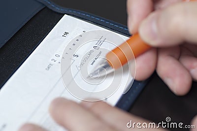 Writing a check Stock Photo