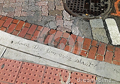 Writing in concrete on a dirty urban street Stock Photo