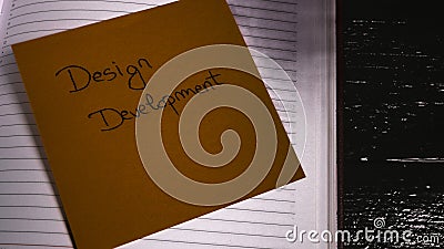 Writing design development on memo post reminder. Text on sticky paper Stock Photo