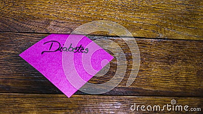 Writing Diabetes on memo post reminder. Text Diabetes on sticky paper Stock Photo