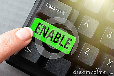 Writing displaying text Enable. Concept meaning give someone or something the authority or means to do something Stock Photo