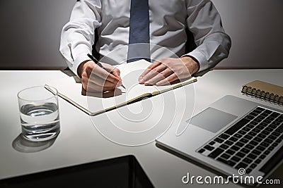 Writing in empty journal Stock Photo