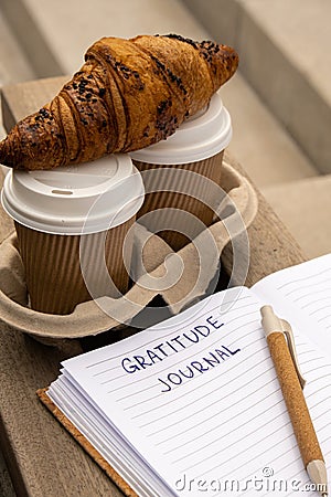Writing Gratitude Journal on wooden bench. Coffee and croissants morning routine. Today I am grateful for. Self Stock Photo