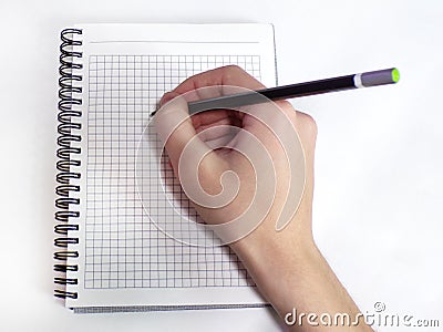 Writing hand on spiral notebook close-up. Stock Photo
