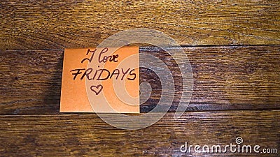 Writing I love fridays on memo post reminder. Text on sticky paper, copy space Stock Photo
