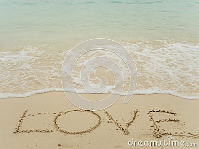 Writing love on beach Stock Photo