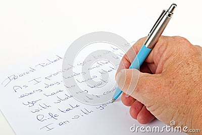 Writing love phrases on a paper with a pen Stock Photo