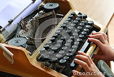 Writing memoirs on an old typewriter - the hands on the keyboard of a typewriter, top view Stock Photo