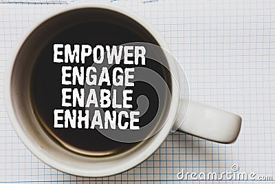 Writing note showing Empower Engage Enable Enhance. Business photo showcasing Empowerment Leadership Motivation Engagement Coffee Stock Photo