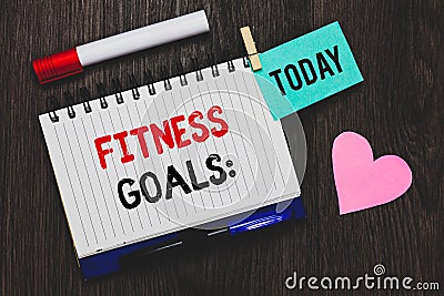 Writing note showing Fitness Goals. Business photo showcasing Loose fat Build muscle Getting stronger Conditioning Open notebook p Stock Photo