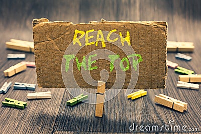 Writing note showing Reach The Top. Business photo showcasing Get Ahead Succeed Prosper Thrive for the Win Victory Clothespin hold Stock Photo