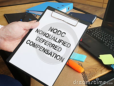 Writing note shows the text nonqualified deferred compensation NQDC Stock Photo