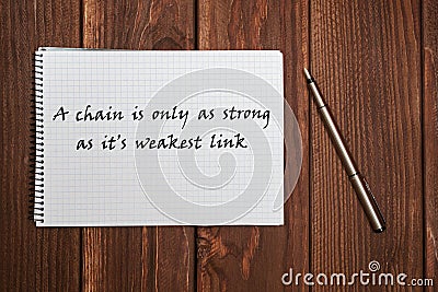 Writing on the notebook. A chain is only as strong as its weakest link Stock Photo