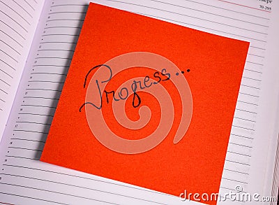 Writing progress on memo post reminder. Text on sticky paper Stock Photo