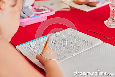 Young girl is writing Spanish Homework Stock Photo