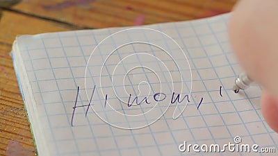 Writing text with a pen in a notebook. A guy writes with a pen in a notebook a letter to his mother: Hello mom, I`m gay .. after writing, he crosses out what was Writing text with a pen in a notebook. A guy writes with a pen in a notebook a letter to his mother: Hello mom, I`m gay .. after writing, he crosses out what was
