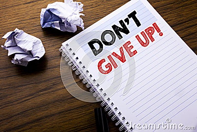 Writing text showing Don t Give Up. Business concept for Motivation Determination, written on notebook notepad note paper on the w Stock Photo