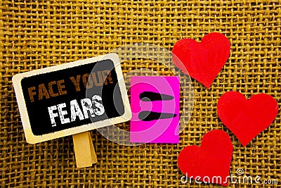 Writing text showing Face Your Fears. Concept meaning Challenge Fear Fourage Confidence Brave Bravery written on blackboard equat Stock Photo