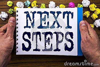 Writing text showing Next Steps. Business concept for Future Golas and Target written on notepad notebook book on the wooden wood Stock Photo