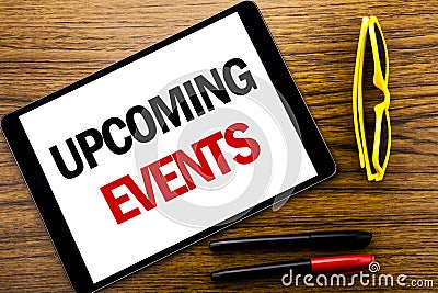 Writing text showing Upcoming Events. Business concept for Appointment Agenda List Written on tablet laptop, wooden background wit Stock Photo