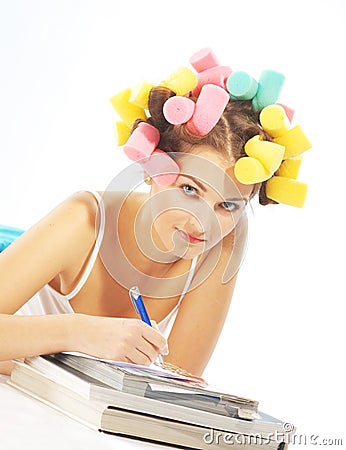 Writing woman in hair curles Stock Photo