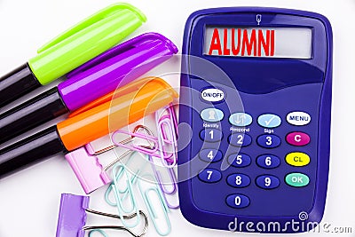 Writing word Alumni Former Students text in the office with surroundings such as marker, pen writing on calculator. Business conce Stock Photo