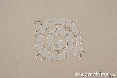 2016 and 2017 written on sand at the beach Stock Photo