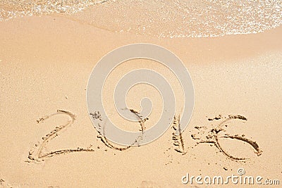 2016 written on sand. Beach and waves Stock Photo