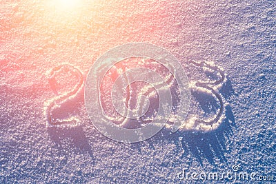 2023 written in the snow illuminated by sunlight. New year and christmas concept Stock Photo