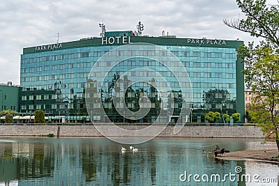 WrocÅ‚aw hotel Park Plaza on the Oder River with swans swimming Editorial Stock Photo