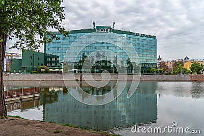 WrocÅ‚aw hotel Park Plaza on the Oder River with swans swimming Editorial Stock Photo