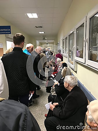Wroclaw, Poland - May 6 2019: Patients of public healthcare waiting in long line to registration room. The line is so long that Editorial Stock Photo
