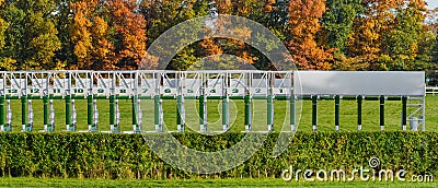 Wroclaw, horse racing track, starting gates for horses, autumn landscape with colorful trees on a sunny day Stock Photo