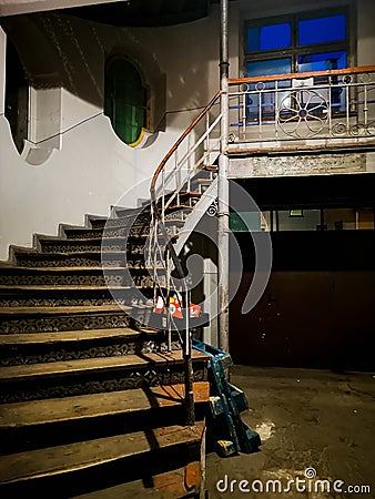 Spiral staircase with big skylight in ceiling and old wooden stairs Editorial Stock Photo