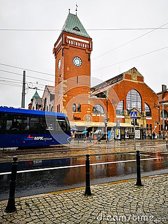 Facade of market hall with riding tram in front of at cloudy rainy day Editorial Stock Photo