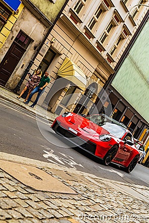 A red sports Porsche driving through the city streets Editorial Stock Photo