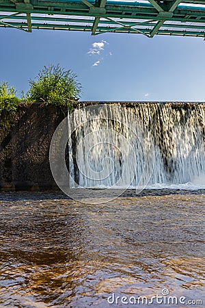 Long Bartoszowicki bridge full of walking tourists and cyclists over water level seen from dried Editorial Stock Photo