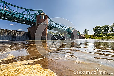 Long Bartoszowicki bridge full of walking tourists and cyclists over water level seen from dried Editorial Stock Photo