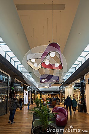Interior of Wroclaw Fashion Outlet as spacious and modern outlet center with shops of many well- Editorial Stock Photo