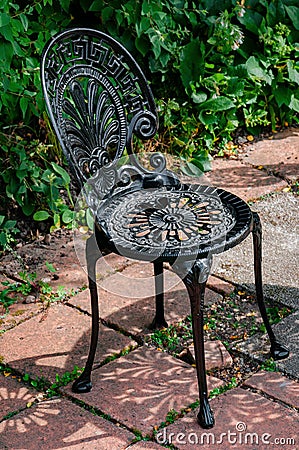 Wrought cast iron chair in the garden black color Stock Photo