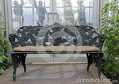 Wrought iron bench in garden Stock Photo