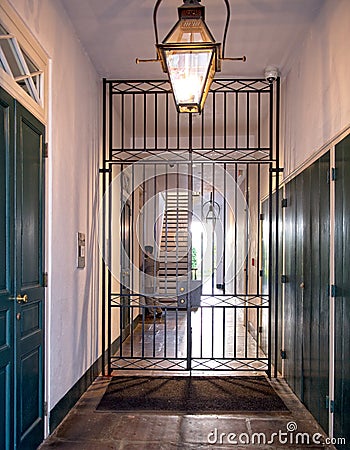 A view of a wrought iron gate in a building alleyway Editorial Stock Photo