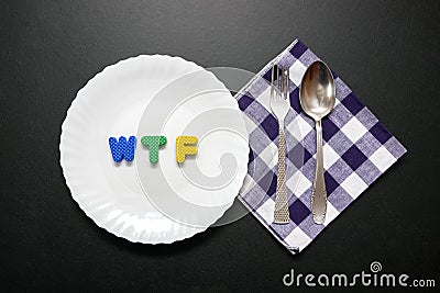 WTF slogan letters on plate with fork and knife Stock Photo