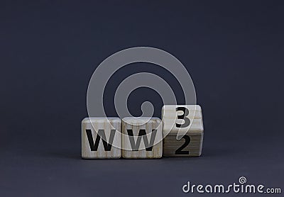 WW3 world war 3 symbol. Turned the wooden cube and changed the concept word WW2 to WW3. Beautiful grey table grey background, copy Stock Photo