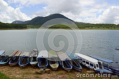 Mountain hill and ferry boats for boat trips on the lake Editorial Stock Photo
